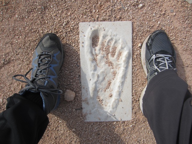Modern feet surround an ancient aboriginal footprint, Mungo Lake, NSW, June 7, 2015